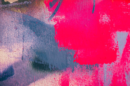 Messy paint strokes and smudges on an old painted wall background. Abstract wall surface with part of graffiti. Colorful drips, flows, streaks of paint and paint spraysの写真素材