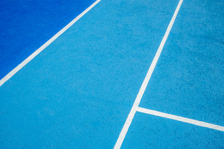 Sport field court background. Light blue rubberized and granulated ground surface with white lines. Top viewの写真素材