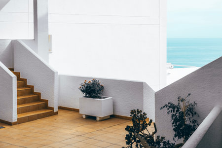 Architectural detail of white mediterranean house by the sea in sunny day. Minimal architecture building detail in Spanish coastline by Mediterranean sea in Spainの写真素材