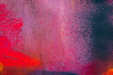 Messy paint strokes and smudges on an old painted wall background. Abstract wall surface with part of graffiti. Colorful drips, flows, streaks of paint and paint spraysの写真素材