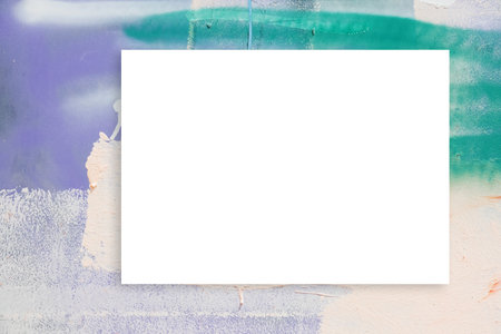 Mock up. Blank white board, billboard, advertising, public information board on colorful wall with pastel colors streaks of paint and paint spraysの写真素材