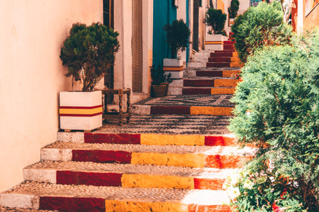 View of Calpe old town on sunny day. Stairs adorned with colors of Spanish flag, Calpe, Alicante province, Valencian Community, Spainの写真素材