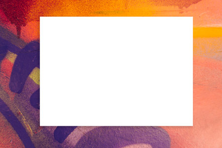 Mock up. Blank white board, billboard, advertising, public information board on colorful graffiti wall with orange, yellow, purple colors streaks of paints and paint spraysの写真素材