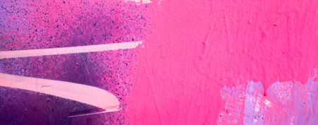 Messy paint strokes and smudges on an old painted wall. Pink, purple, white color drips, flows, streaks of paint and paint spraysの写真素材