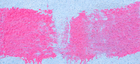 Pink paint strokes and smudges on an old light blue wall background. Abstract urban banner backgroundの写真素材