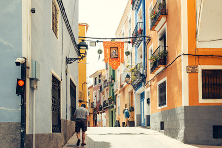 View to beautiful Villajoyosa street with multi-colored houses. Villajoyosa - coastal town in Alicante Province, Valencian Community, Spain, by Mediterranean Sea. Villajoyosa, Spain - May 09, 2023のeditorial素材
