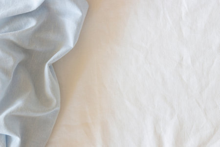 Abstract crumpled linen fabric texture background. Natural light blue hue dyed linen and white color blend linen fabric background. Top viewの写真素材