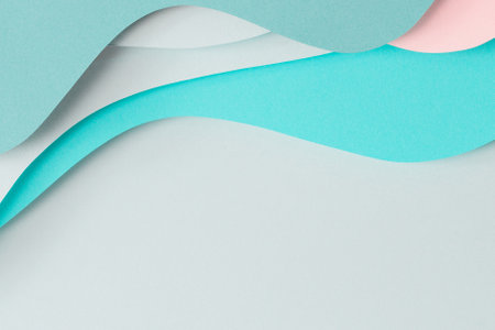 Abstract colored paper texture background. Paper cut composition with layers of geometric shapes and lines in turquoise, aquamarine, pastel green and pink colors. Top viewの写真素材