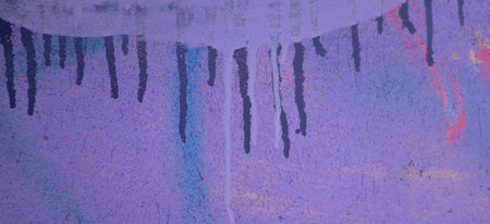Messy paint strokes and smudges on an old painted wall with graffiti. Colorful drips, flows, streaks of paint and paint spraysの写真素材