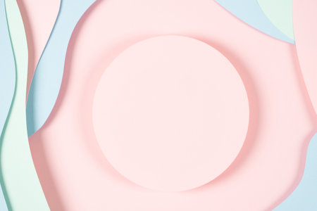 Blank pink round geometric shape podium platform on paper cut abstract geometric shape pastel pink, blue and green background. Top view mock up for product displayの写真素材