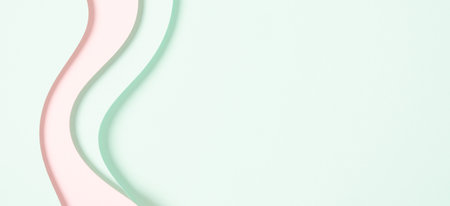 Abstract colored paper texture background. Minimal paper cut composition with layers of geometric shapes and lines in light green and pastel pink colors. Top view, copy spaceの写真素材