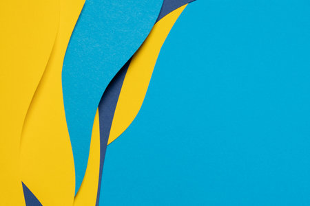Abstract colored paper texture background. Minimal paper cut composition with layers of geometric shapes and lines in light blue, navy blue, yellow colorsの写真素材
