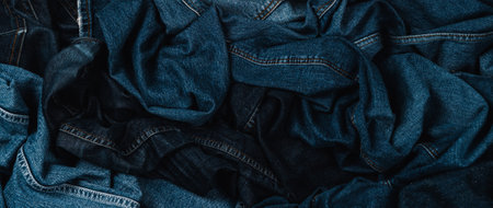 Denim background. Variety of crumpled blue jeans. Top view to stack of jeans denimの写真素材