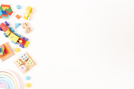 Baby kids toy background. Wooden educational, musical, sensory, sorting and stacking toys on white background. Montessori toys. Top view, flat layの写真素材