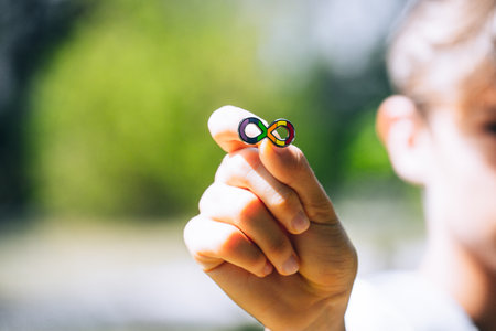 Autism infinity rainbow symbol sign in kid hand. World autism awareness day, autism rights movement, neurodiversity, autistic acceptance movementの写真素材