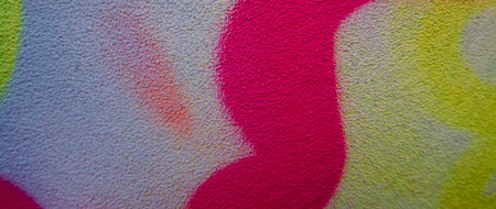 Fragment of the wall with colorful graffiti painting in the street. Part of colorful street art graffiti on wall backgroundの写真素材