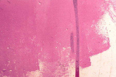 Messy paint strokes and smudges on an old painted wall. Pink, magenta color drips, flows, streaks of paint and paint spraysの写真素材