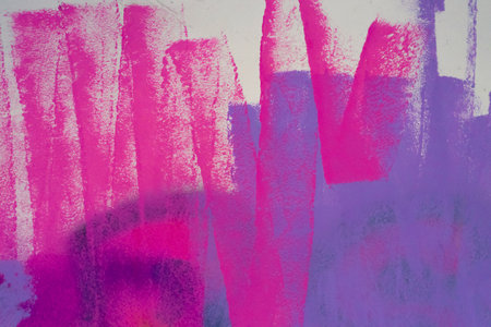 Messy paint strokes and smudges on an old painted wall. Pink, purple, white color drips, flows, streaks of paint and paint spraysの写真素材