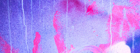 Messy paint strokes and smudges on an old painted wall. Pink, purple, white color drips, flows, streaks of paint and paint spraysの写真素材