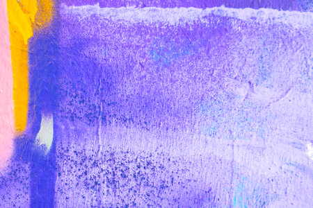 Messy paint strokes and smudges on an old painted wall. Pink, purple, white color drips, flows, streaks of paint and paint sprays on purple wall backgroundの写真素材