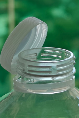 Stationary plastic cap attached on disposable plastic bottle of drinking water, mineral water or soft drink. Ecology, recycling, environmental protection, pollution reduction conceptの写真素材
