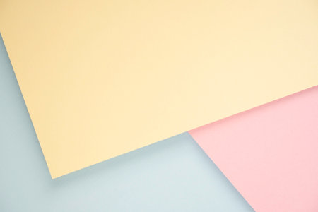 Abstract geometric background with minimal geometric shapes and lines. Light blue, pastel pink and yellow colored paper layout background with copy space for text.の写真素材