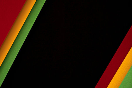 Abstract geometric black, red, yellow, green color paper background. Black History Month color background with copy space for textの写真素材