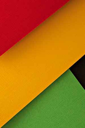 Abstract geometric black, red, yellow, green color background. Colorful papercut layout backgroundの写真素材