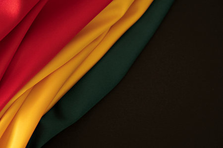 Black History Month background. Red, yellow, green colors drapery, silk flag background. Top viewの写真素材