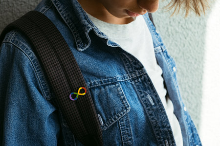 Teenage boy with autism infinity rainbow symbol sign. World autism awareness day, autism rights movement, neurodiversity, autistic acceptance movementの写真素材