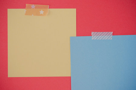 Blank blue and yellow memo square notes on red background. Empty memo note mockup with ripped...