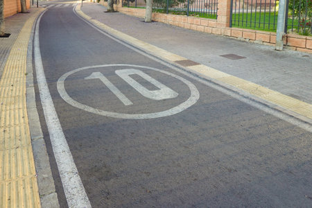 Traffic speed limit. 10 km h speed limit marking on the road in quiet residential area in Benidorm,...