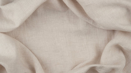 Beige neutral natural linen fabric with subtle wrinkles forming frame with copy space for text. Top...