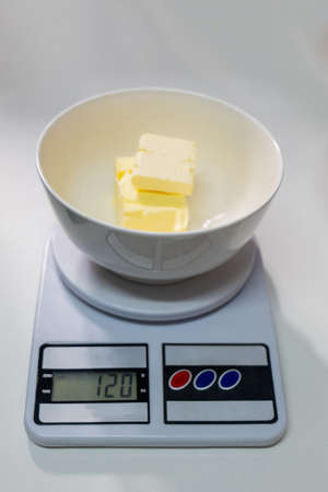 Weigh the butter for the perfection of the bread recipe.の写真素材