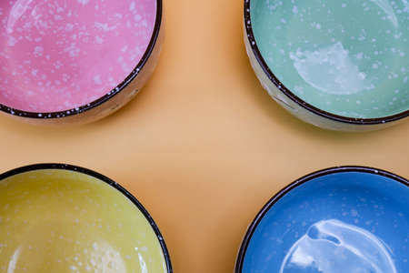 The rice cup is made of ceramic, four colors, green, yellow, pink, blue, high angle shot.の写真素材