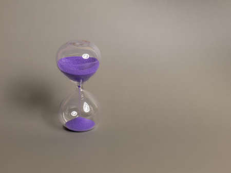 The hourglass was shot in a studio, the sand inside flows down with time, which can be further developed.の写真素材