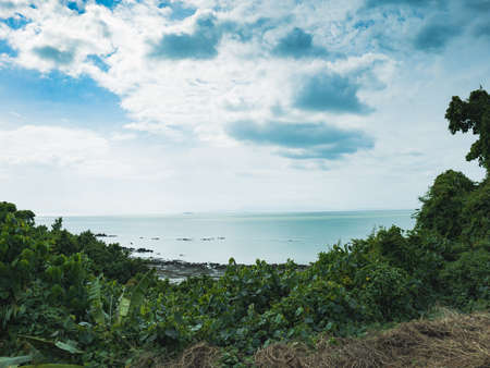 A panoramic view of the sea, trees and sky in southern Thailand.の写真素材