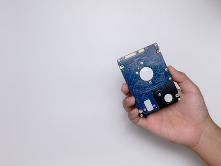 Hands are sending HDD as a process of repairing or upgrading your computer or laptop to SSD to be...