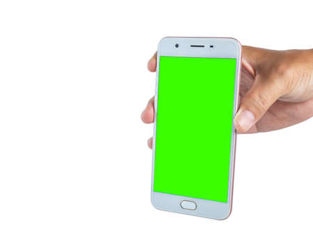 hand holding a white cell phone The screen was cut into a green scene.の写真素材
