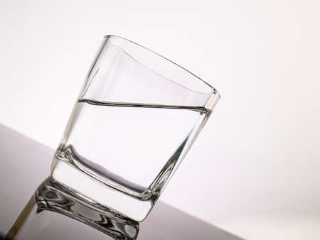 glass for liquor Translucent elements made of glass are placed on a tilted table. empty objects...