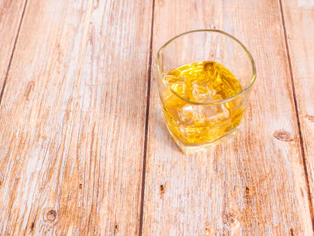 glass for liquor Translucent elements made of glass are placed on a wooden table. empty objects isolated on white backgroundの写真素材