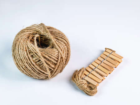 coiled raw rope Made of various fibers into a long rope. Empty with a small clip made of wood. For...