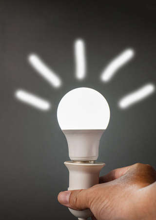 mobile led bulb that illuminates white light on a black background. In the dark, apply a white line effect around the lamp.の写真素材
