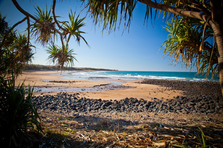 Rocky Sandy Beach and Sea Shore on a beautiful blue sky day. Photo is of Mon Repos Beach near Bundaberg, Australiaの写真素材