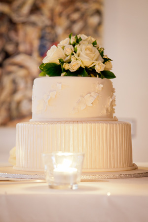 A Wedding Cake with Flowers on the top and beautiful icing decorationsの写真素材