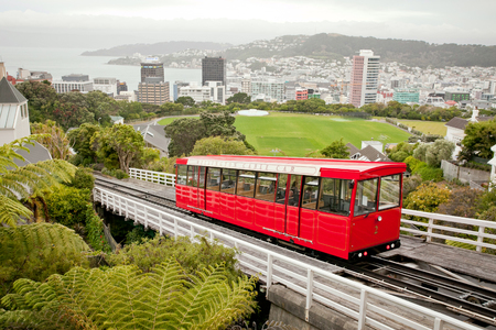 WELLINGTON, NEW ZEALAND - DECEMBER 27, 2016: The Wellington Cable Car reaches the top of the hill. Wellington city - New Zealand's capital in the background.のeditorial素材