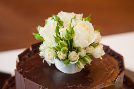 Chocolate layered wedding cake with rose flowers detailの写真素材