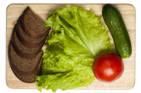 vread and vegetables on the board isolated on whiteの写真素材