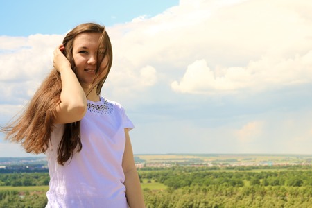 Young successful female Model on blue sky backgroundの写真素材