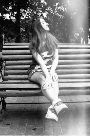 Beautiful model sits on a bench in the Park. Summer. black and white photographyの写真素材